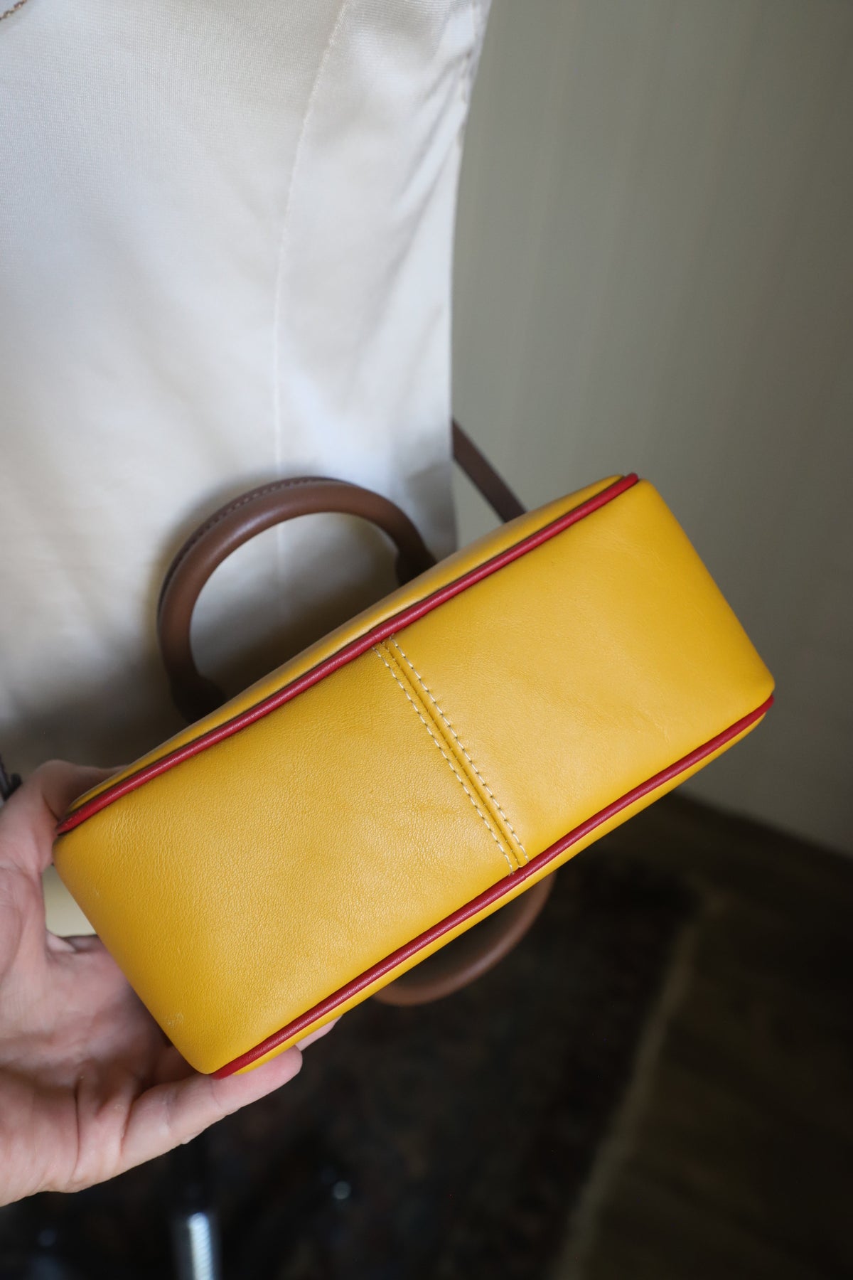Small yellow Coach bag with cross strap