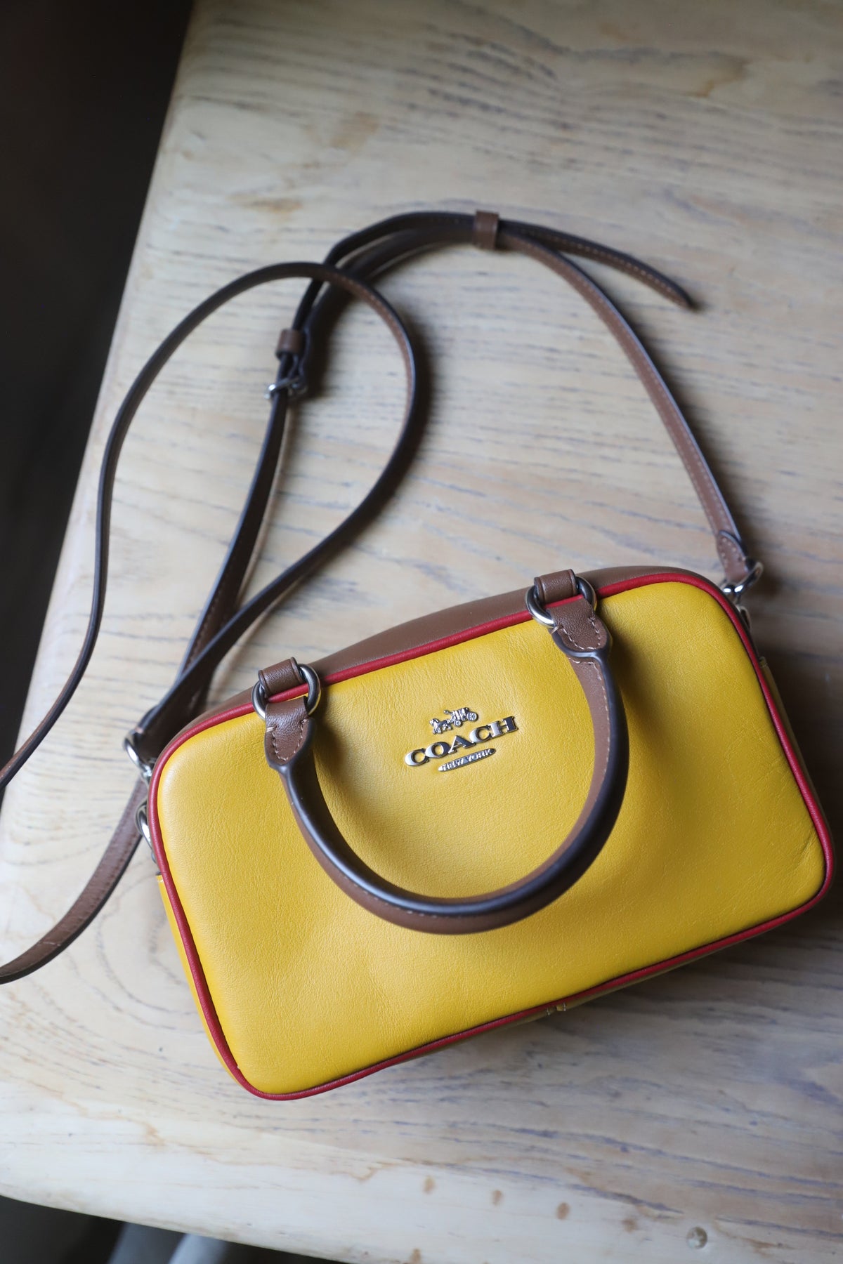 Small yellow Coach bag with cross strap